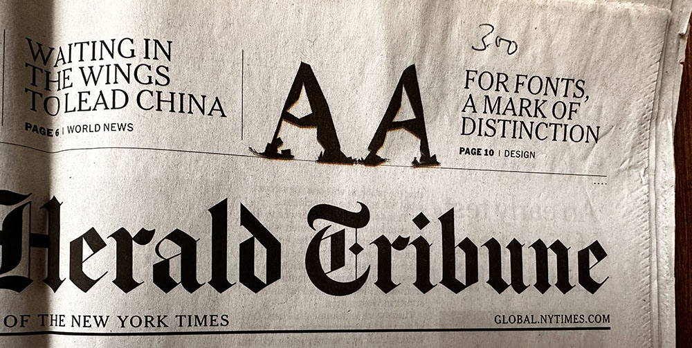 Photo of the cover of the International Herald Tribune, January 24, 2011. Part of the masthead is visible. Two A's from LTR Beowolf in the top right.